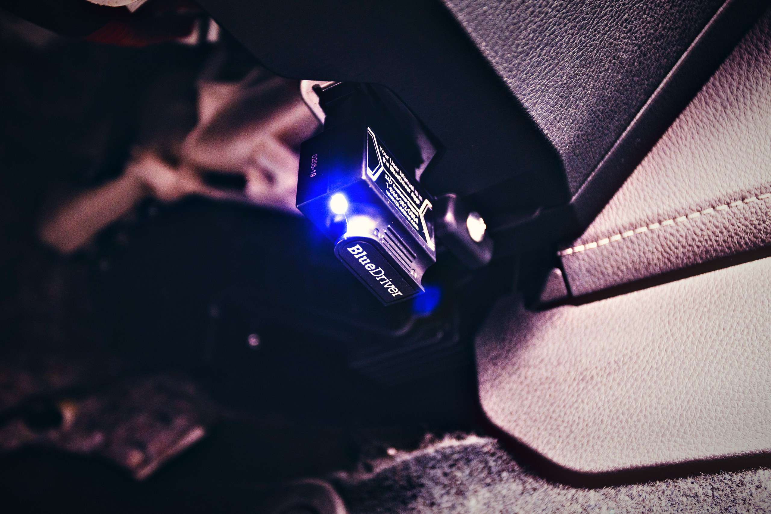 OBD diagnostic scanner plugged into a vehicle