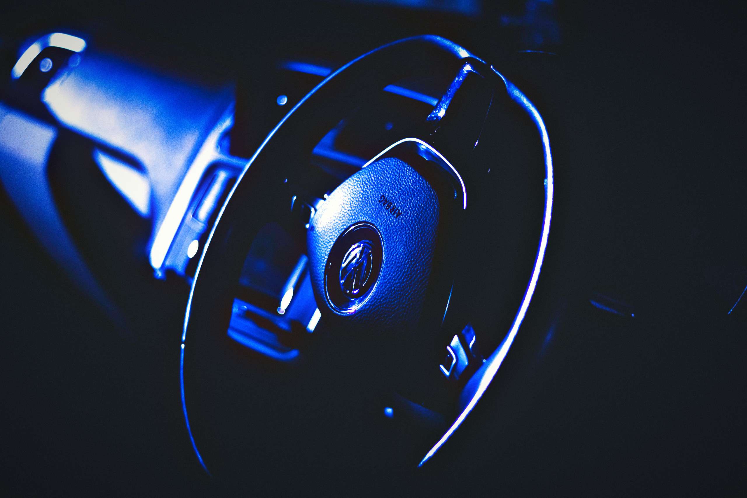 Dark artistic photo of a steering wheel with key