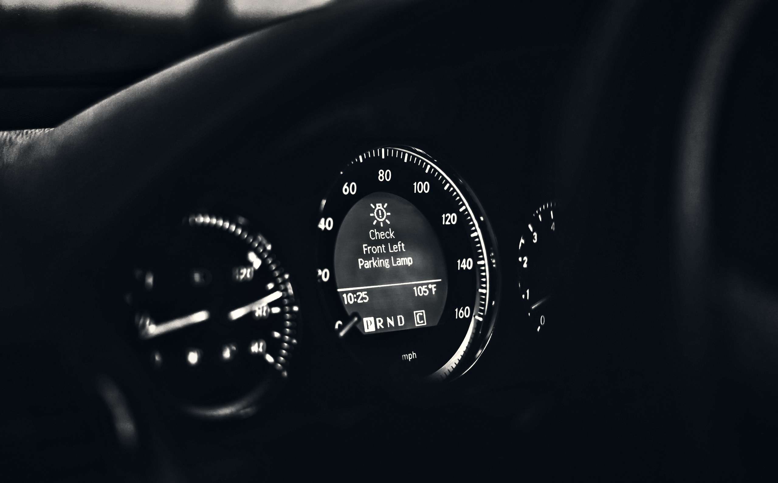 Close-up of a car dashboard with warning lights