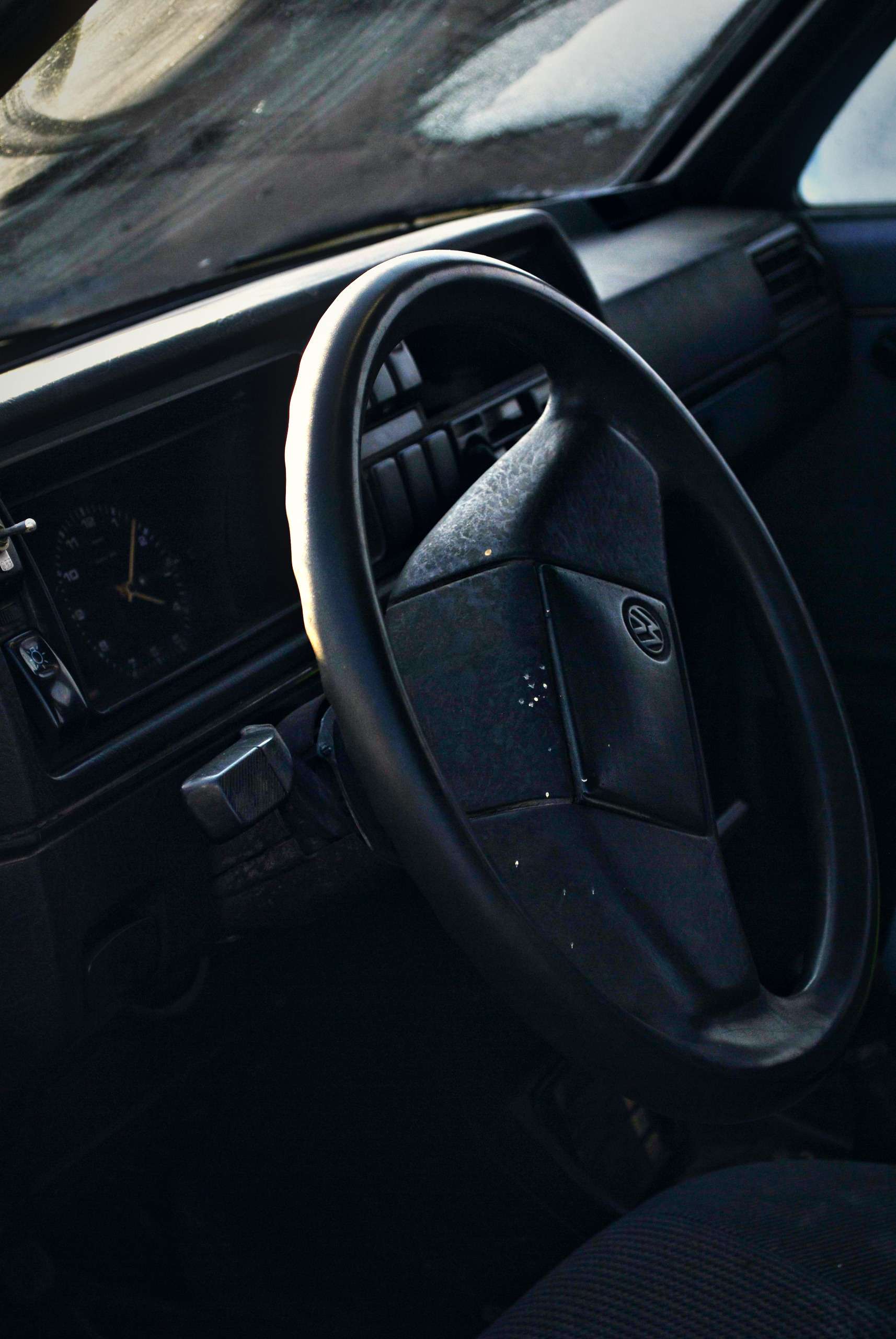 Classic car steering wheel in shadow