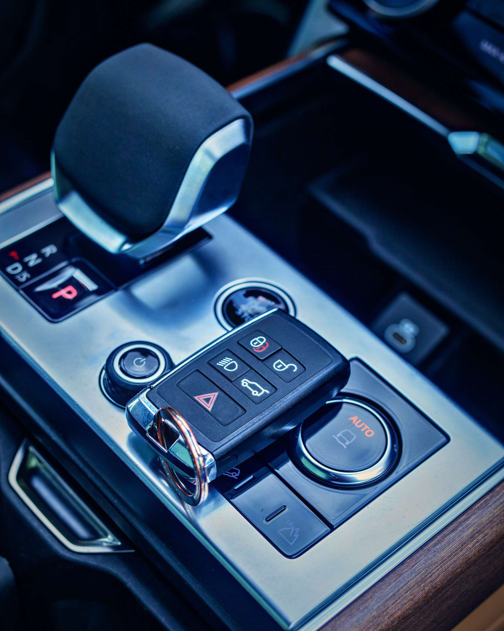 Car remote key fob resting on a vehicle's center console
