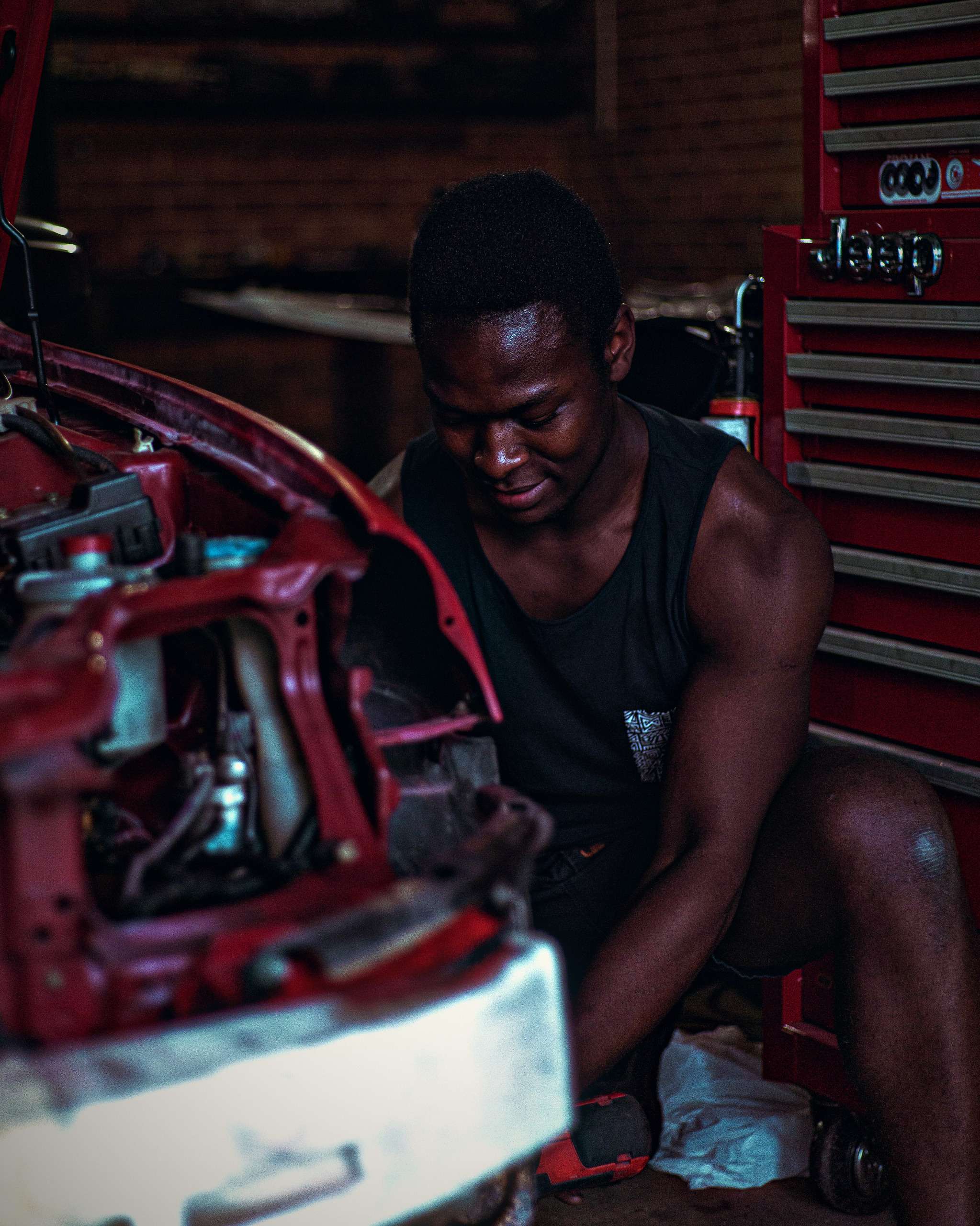 Mechanic repairing a car engine in a garage