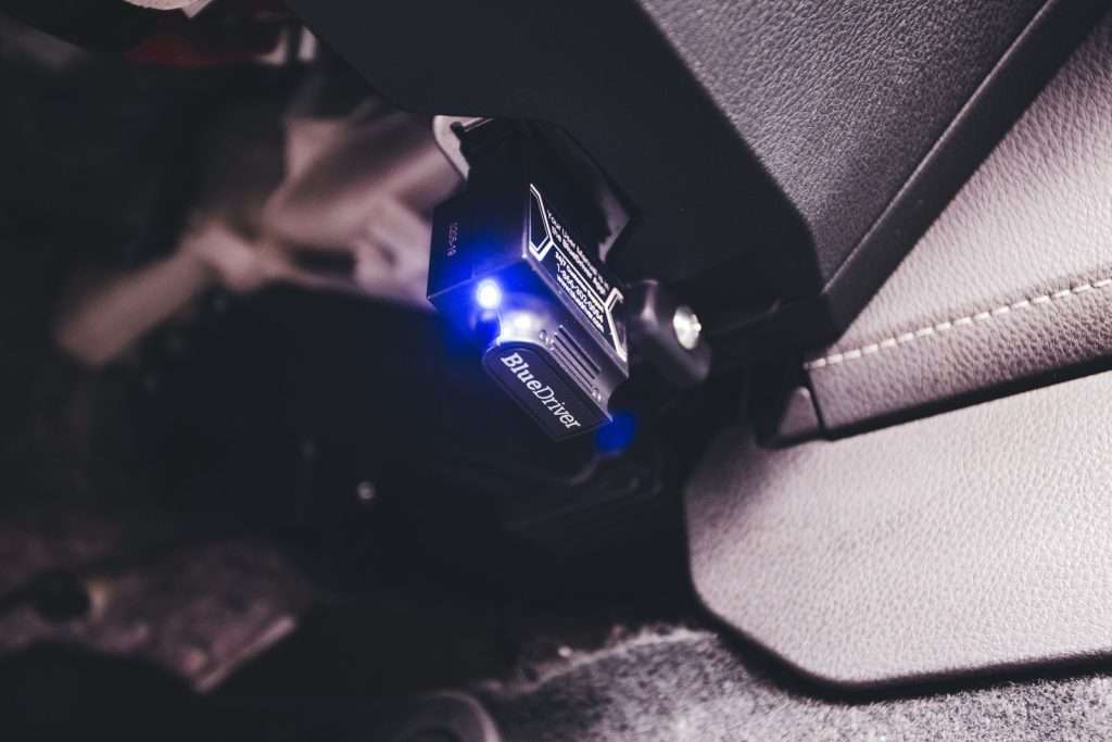 OBD diagnostic scanner plugged into a vehicle