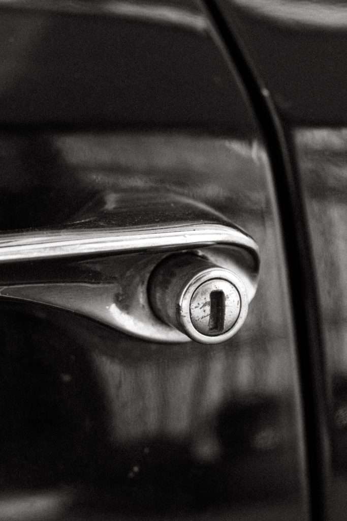 Monochrome close-up of a car door lock