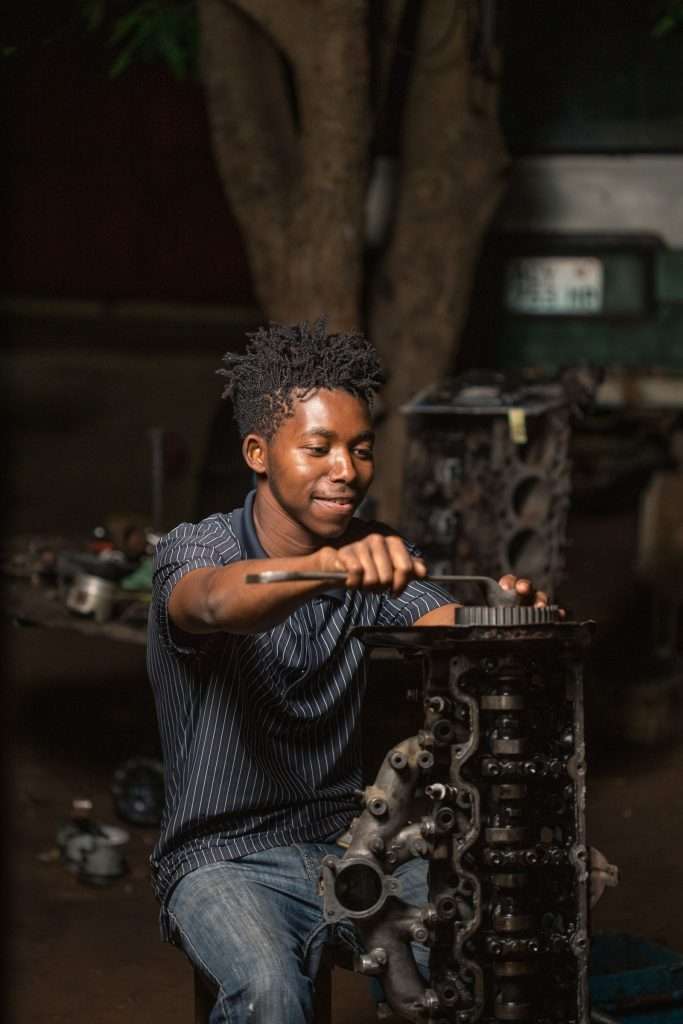 Mechanic working on a car engine in a workshop